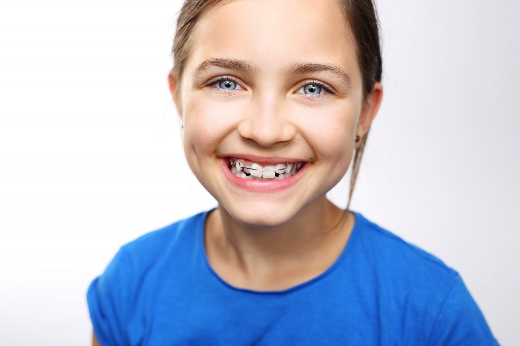 Young girl with braces smiling