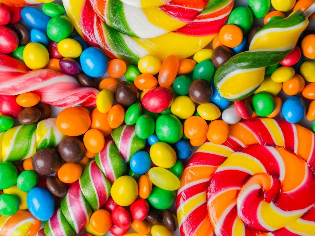 Colorful assortment of candies showing what candy can you eat with braces.